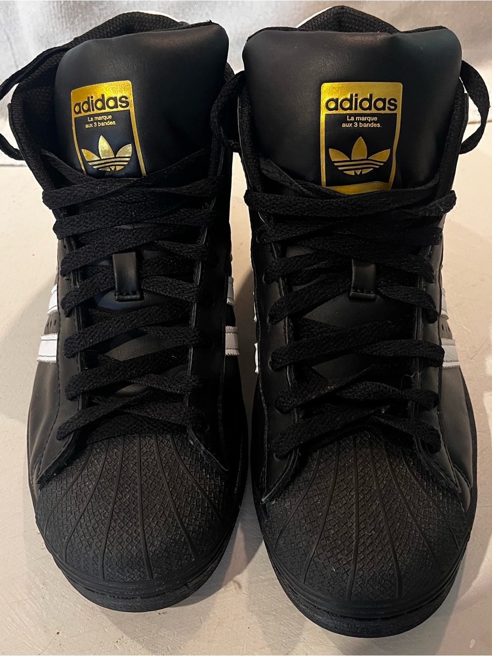 adidas Black High-Top Sneakers with White Stripes and Gold Logo